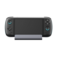 Black handheld gaming console with a stand on a white background