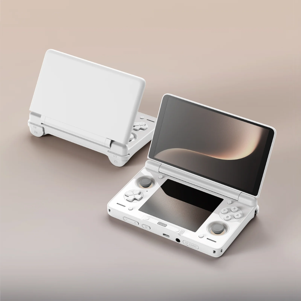 White handheld gaming console with screen open on a beige background