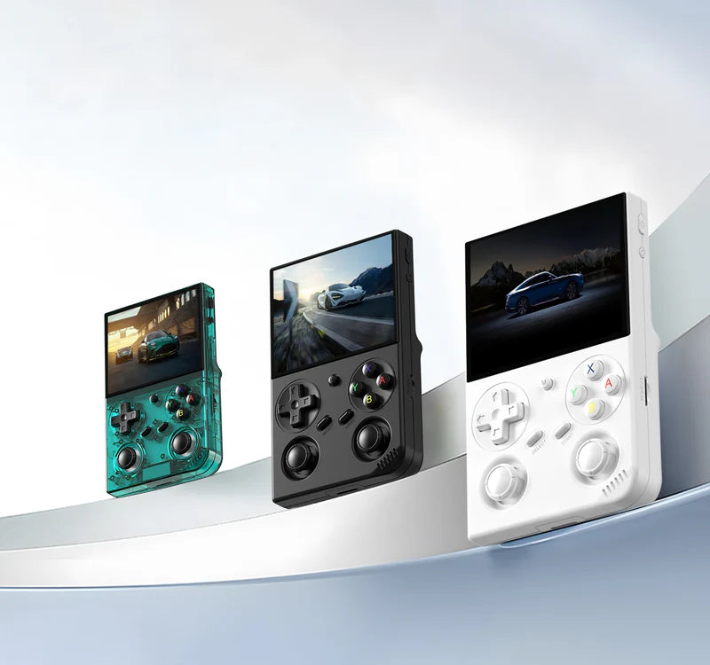 Three handheld gaming consoles in different colors on a white surface with a light gray background.