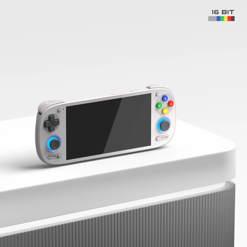 Handheld gaming console with a screen and control buttons on a white surface.