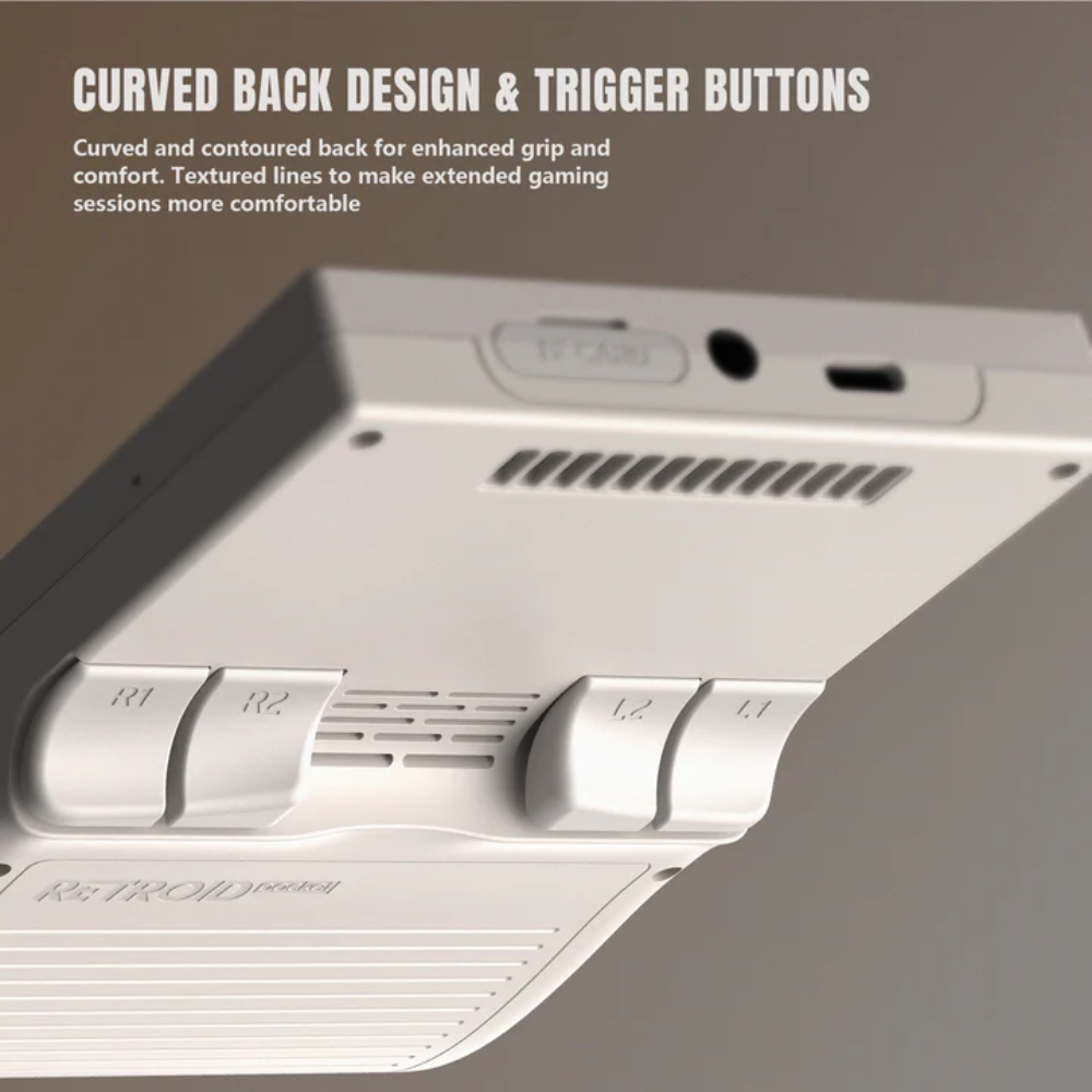 Close-up of a gaming controller with curved back design and trigger buttons on a gray background.