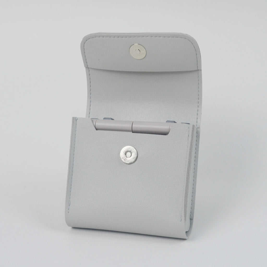 Gray case with button closures on a light gray background