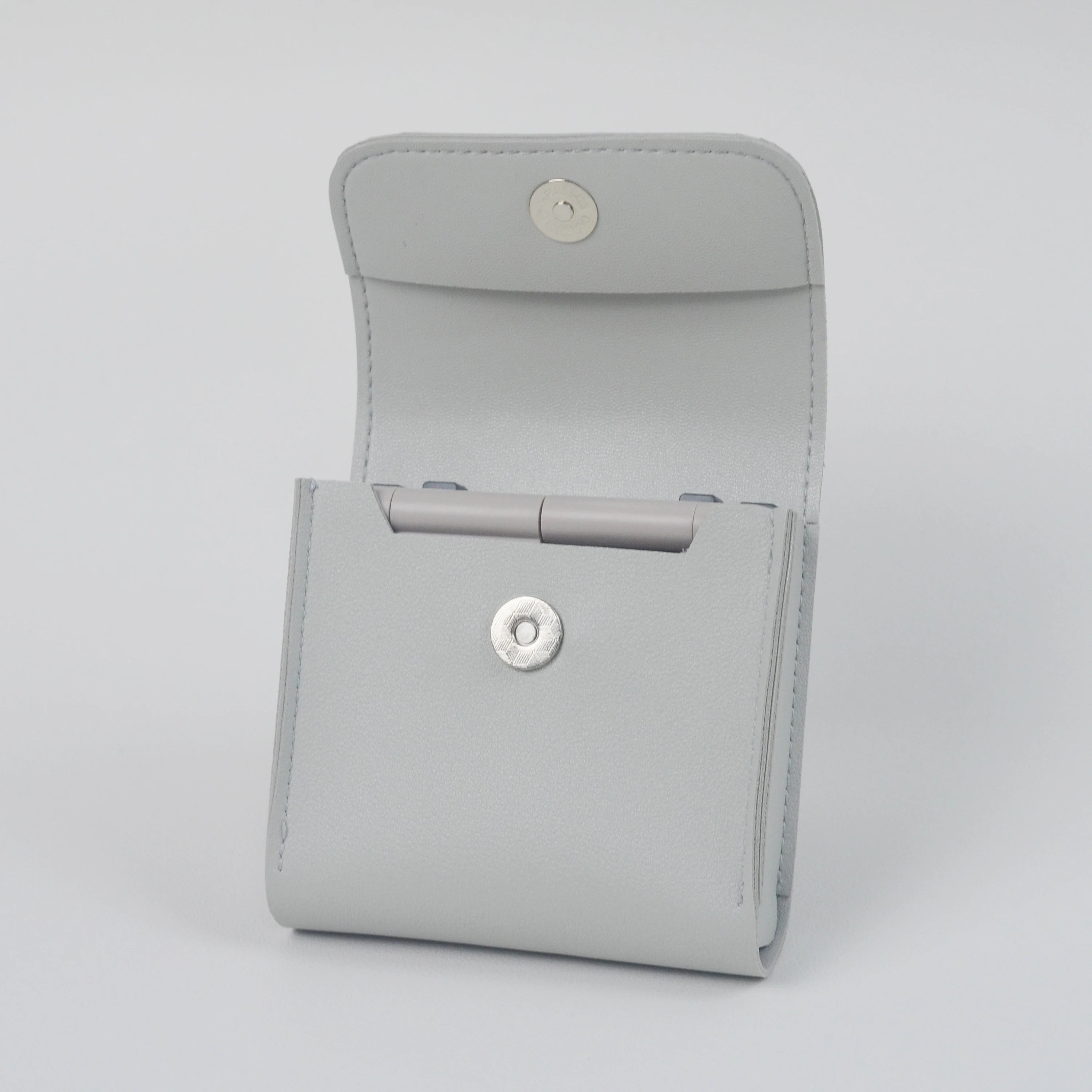 Gray case with button closures on a light gray background