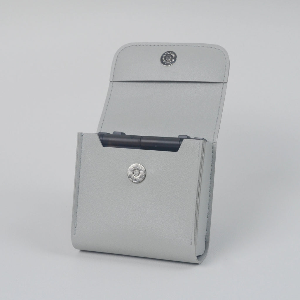 Gray case with button details on a light gray background