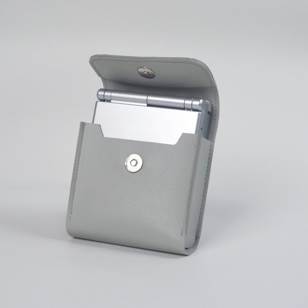 Gray clutch bag with a console on a light gray background