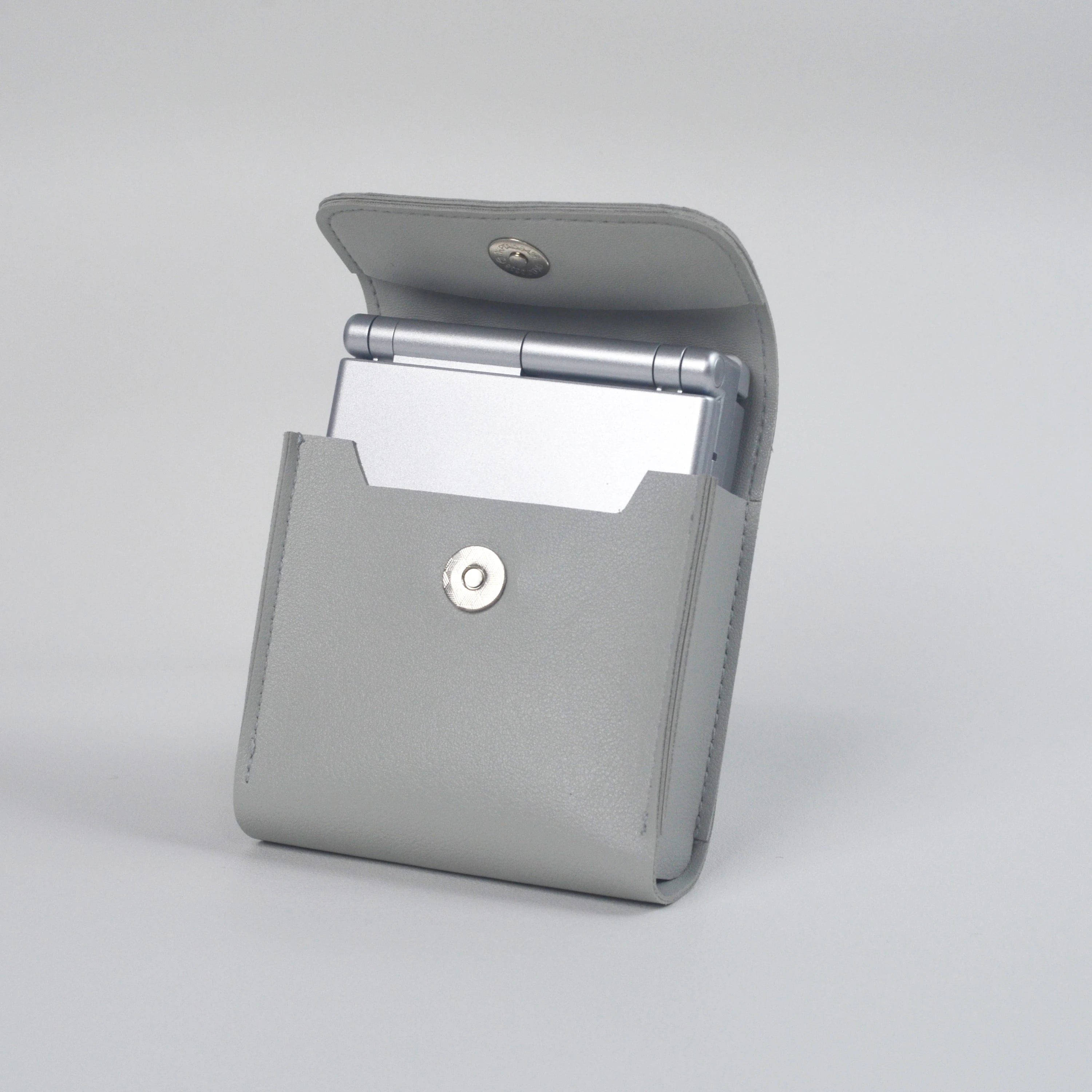Gray clutch bag with a console on a light gray background