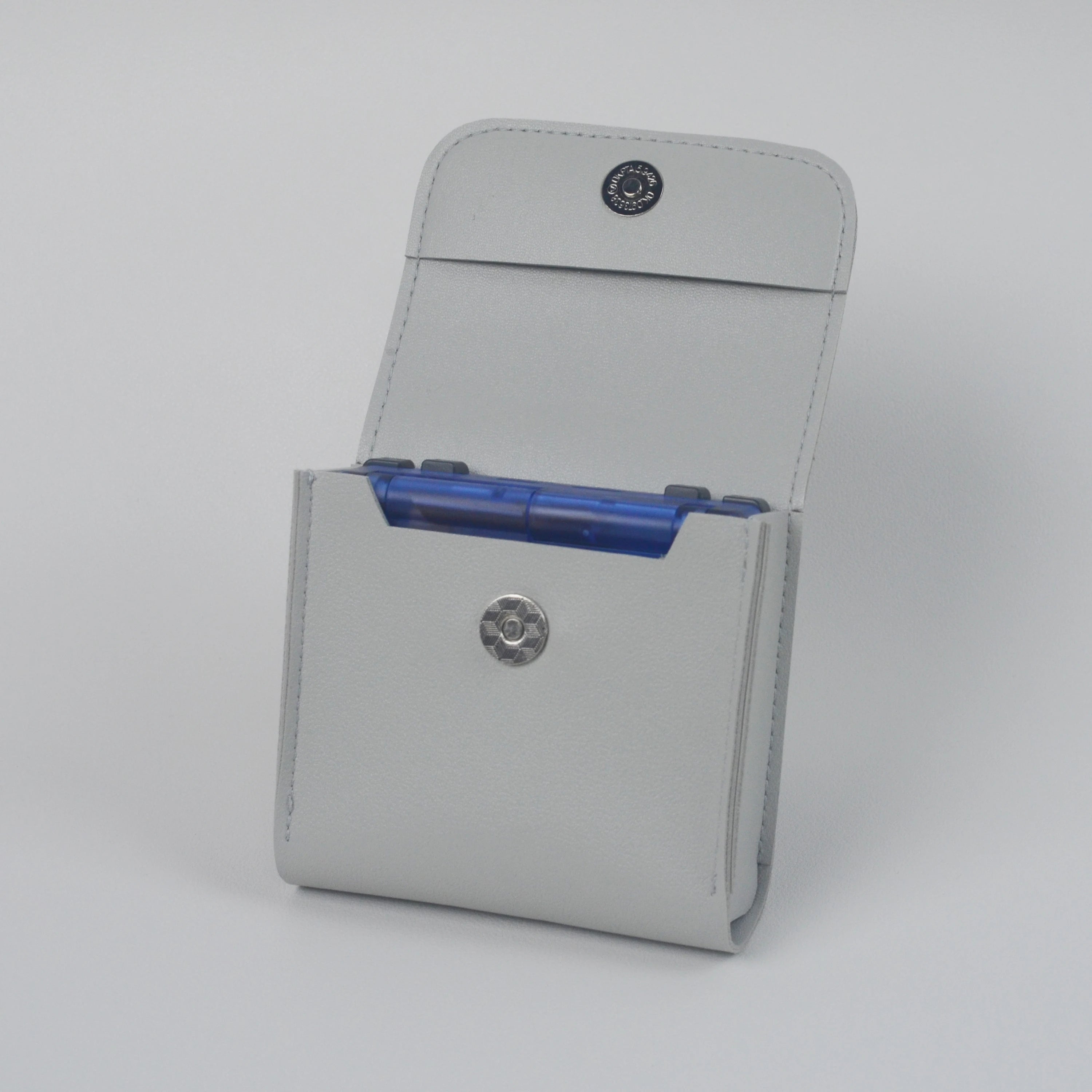 Gray cardholder with blue cards on a light gray background
